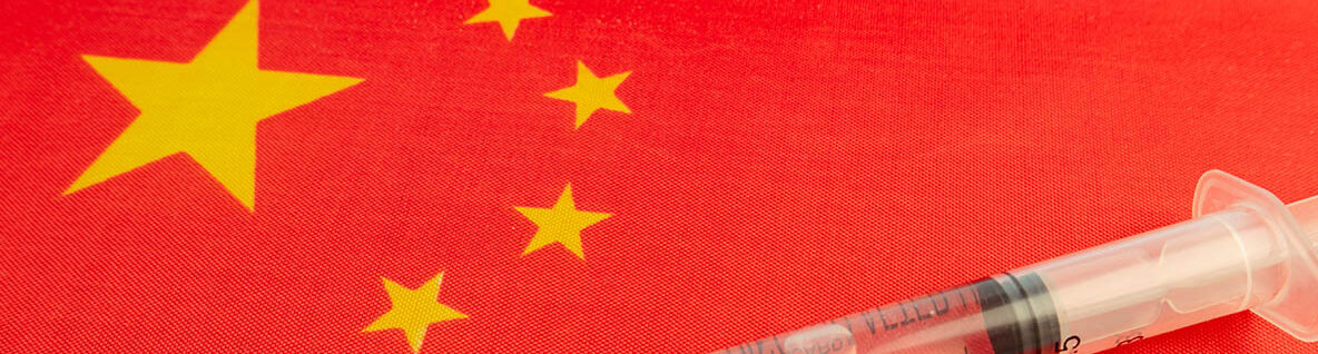 Vaccine, syringes and Chinese flag. Microbiological research in China. Development of antiviral drugs in the Republic of China. bottle covid-19 vaccine. Sinovac new china vaccine. Atopic Dermatitis